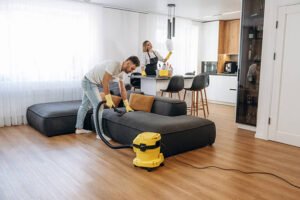 modern interior of home. two cleaning service workers are in domestic room.
