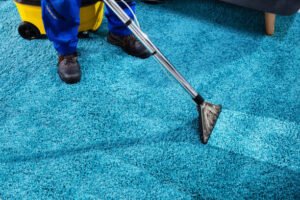close up of a person cleaning carpet with vacuum cleaner